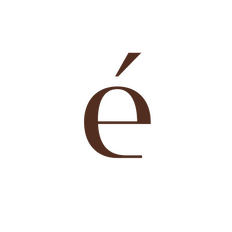 The Le Ligne pendant lighting by Dotéa in a minimalist, warm-toned dining room. High-end shatter-proof home goods for family-friendly luxury.